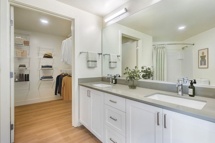 Renovated Package I bath with white cabinetry, grey quartz countertops and hard surface flooring