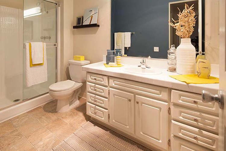Classic Package I bath with white tile countertop, white cabinetry, and vinyl tile flooring