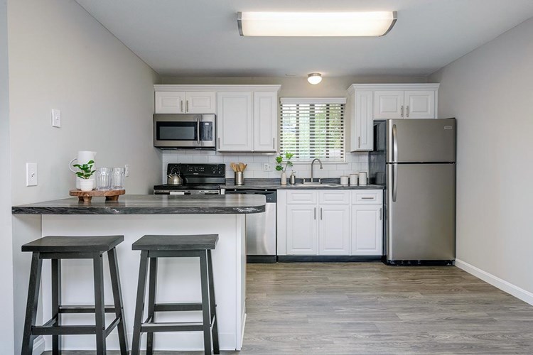 Large, open kitchens with stainless steel appliances and ample cabinetry.