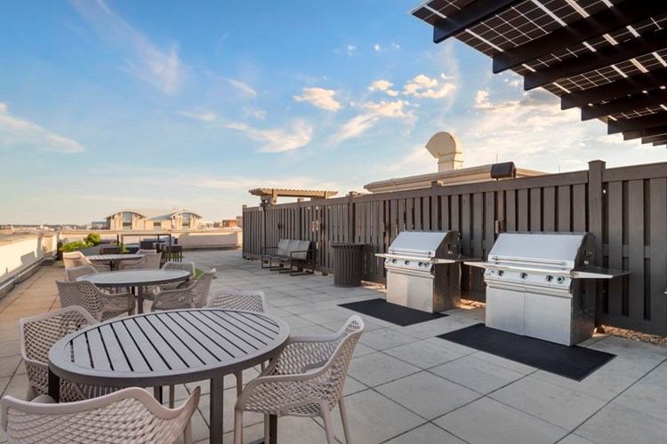 Rooftop terrace with barbecue grills and dining area