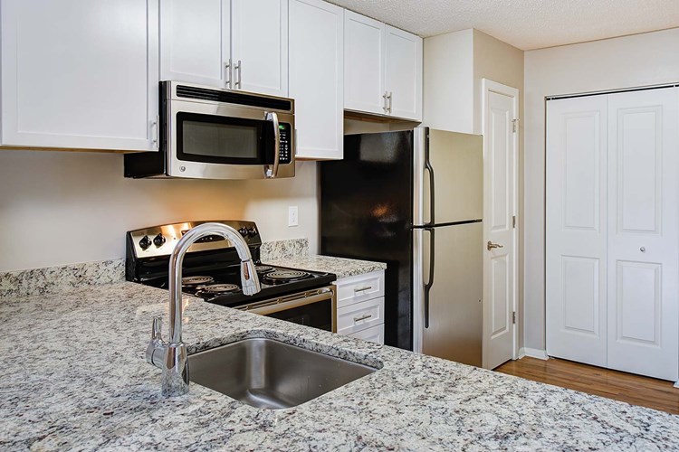 Modern kitchens include granite countertops and GE Clean Steel appliances