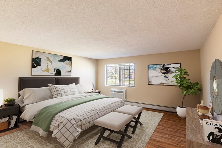 Large bedroom with wood flooring and ample natural light