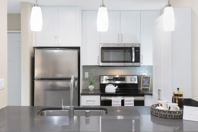 Modern Collection Kitchen With Quartz Countertops Ceramic Tile Backsplash And Stainless Appliances