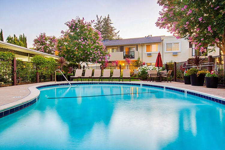 Pool with lounge chairs at Pleasanton Place Apartment Homes
