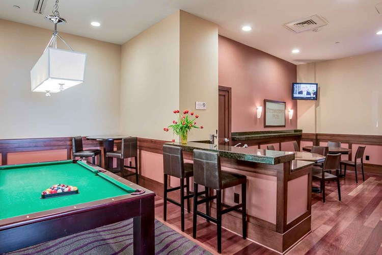 Clubroom with billiards and poker table