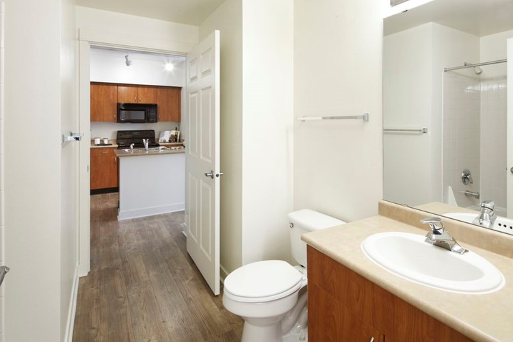 Classic Package I bath with laminate countertops, oak cabinetry, and hard surface flooring