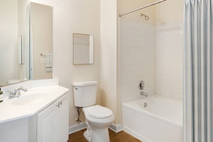 Classic II bath with white cabinetry, white laminate countertops, and hard surface flooring