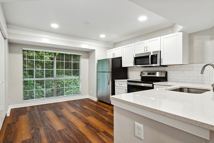Large kitchen with stainless steel appliances, breakfast bar and great natural lighting