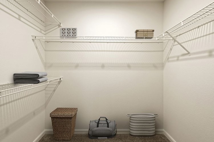Walk in closet with linen rack and storage space