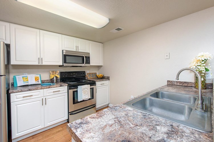 Large kitchens, fully equipped with stainless steel appliances and in-home laundry room.