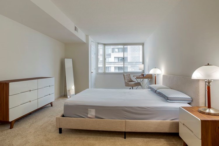 Furnished+ apartment homes feature queen bed with mattress, two pillows, dresser, nightstands, lamp, and mirror. (Representative Image – exact items and style of furnishings may vary)