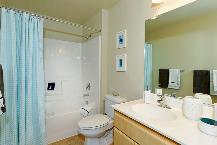 Classic Package I bath with white laminate countertops, light cabinetry, and tile flooring