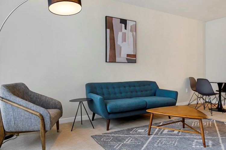 Furnished+ apartment homes come outfitted with a sofa, side chair, side table, coffee table, TV stand and 50" Television (Representative Image – exact items and style of furnishings may vary)