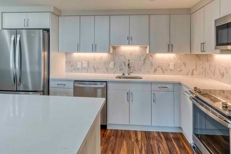 Premier homes feature modern kitchens with upgraded refrigerators, granite countertops and separate dining space