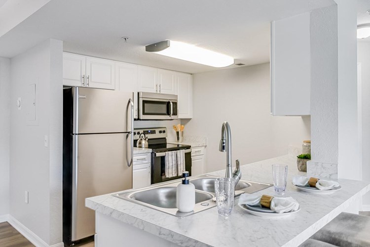 Our updated kitchens feature wood-style flooring, ample cabinetry, and stainless-steel appliances.