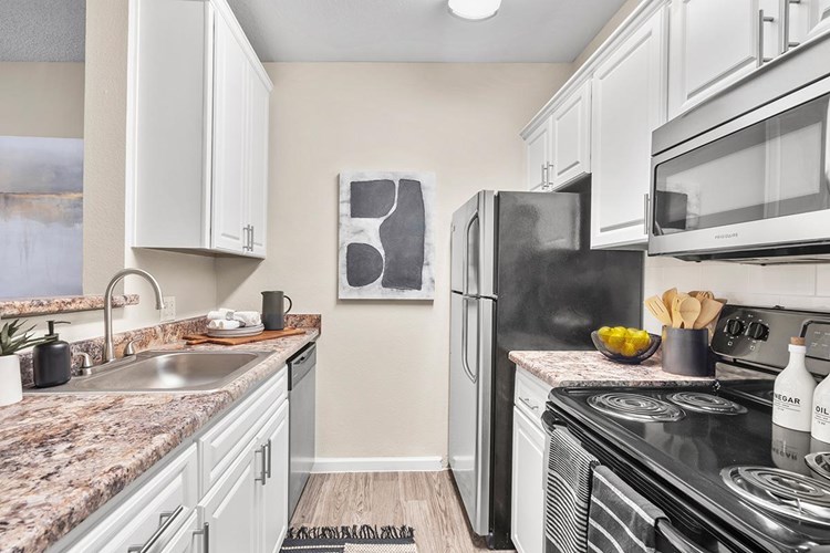 Your newly renovated kitchen is complete with a tile backsplash and breakfast bar.