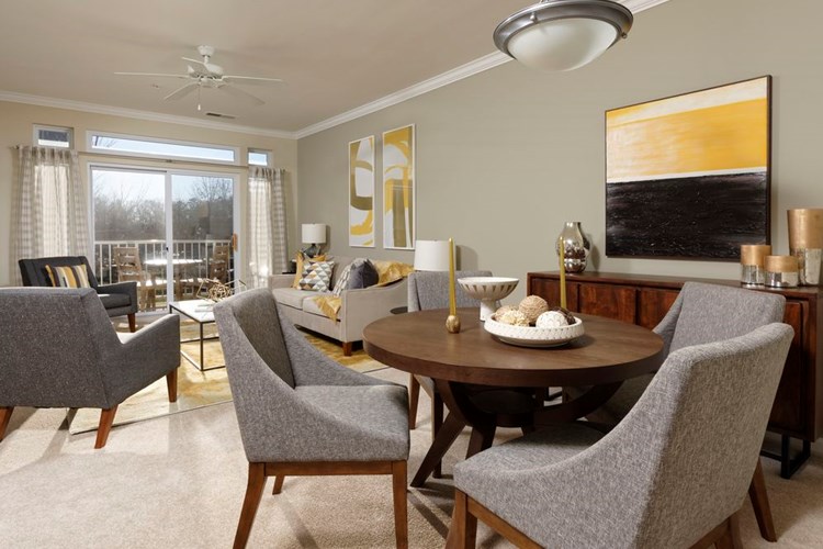 Classic Package I living and dining areas with ceiling fan and carpeted flooring