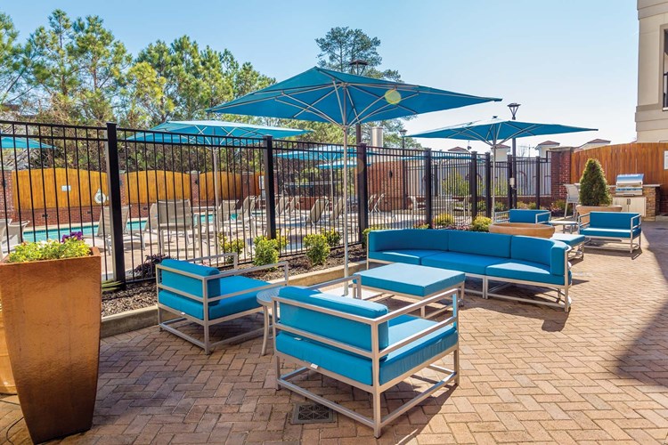 Host a BBQ on the outdoor, poolside patio with stainless steel grill