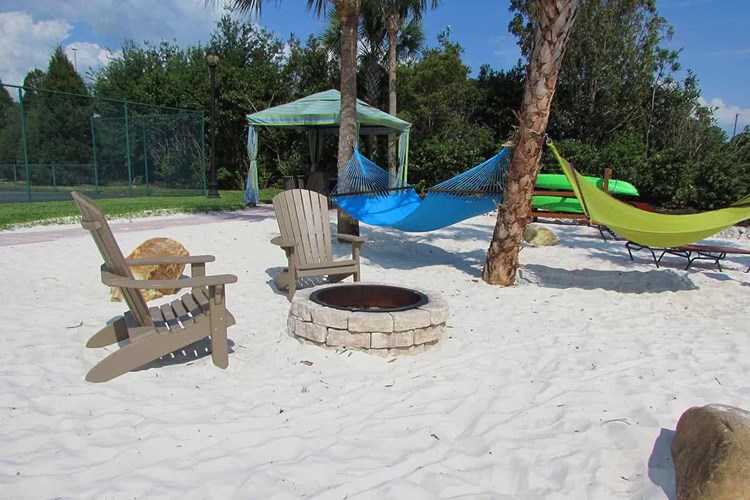 Enjoy a fire at our outdoor fire pit on our beach area next to the hammock garden.