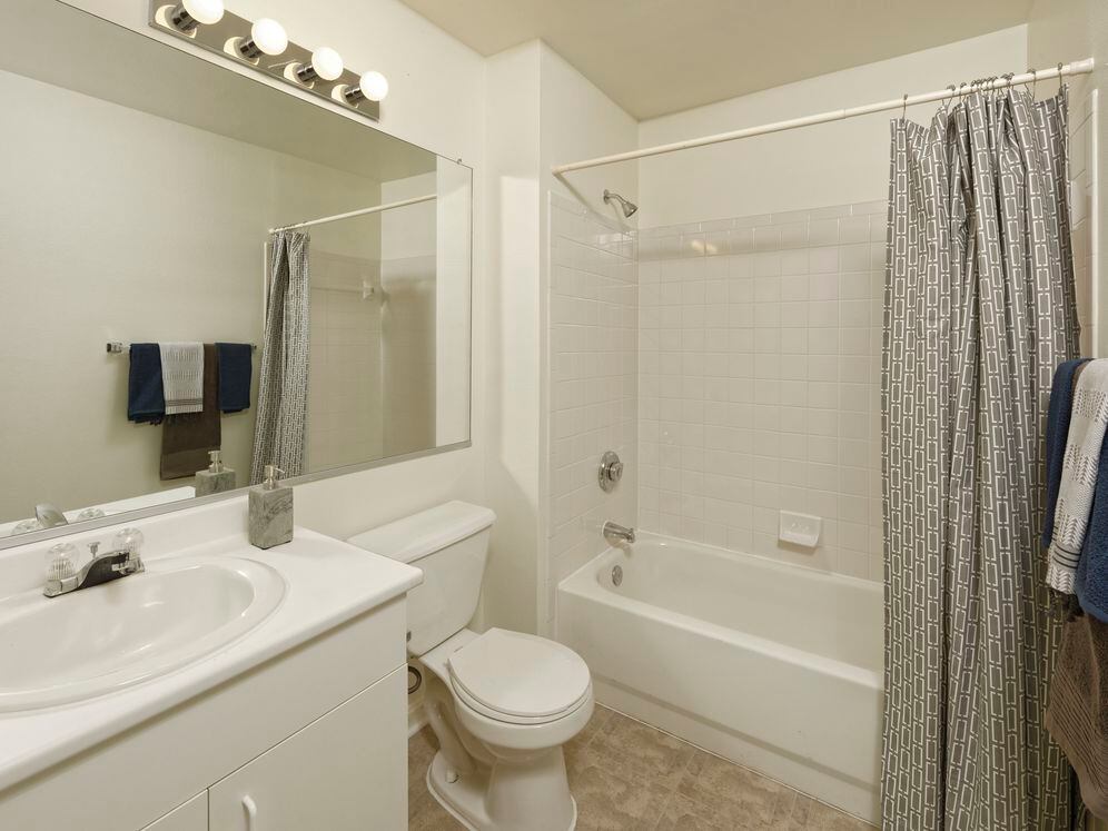 Classic Package I bath with white cabinetry, white laminate countertop, and vinyl tile flooring