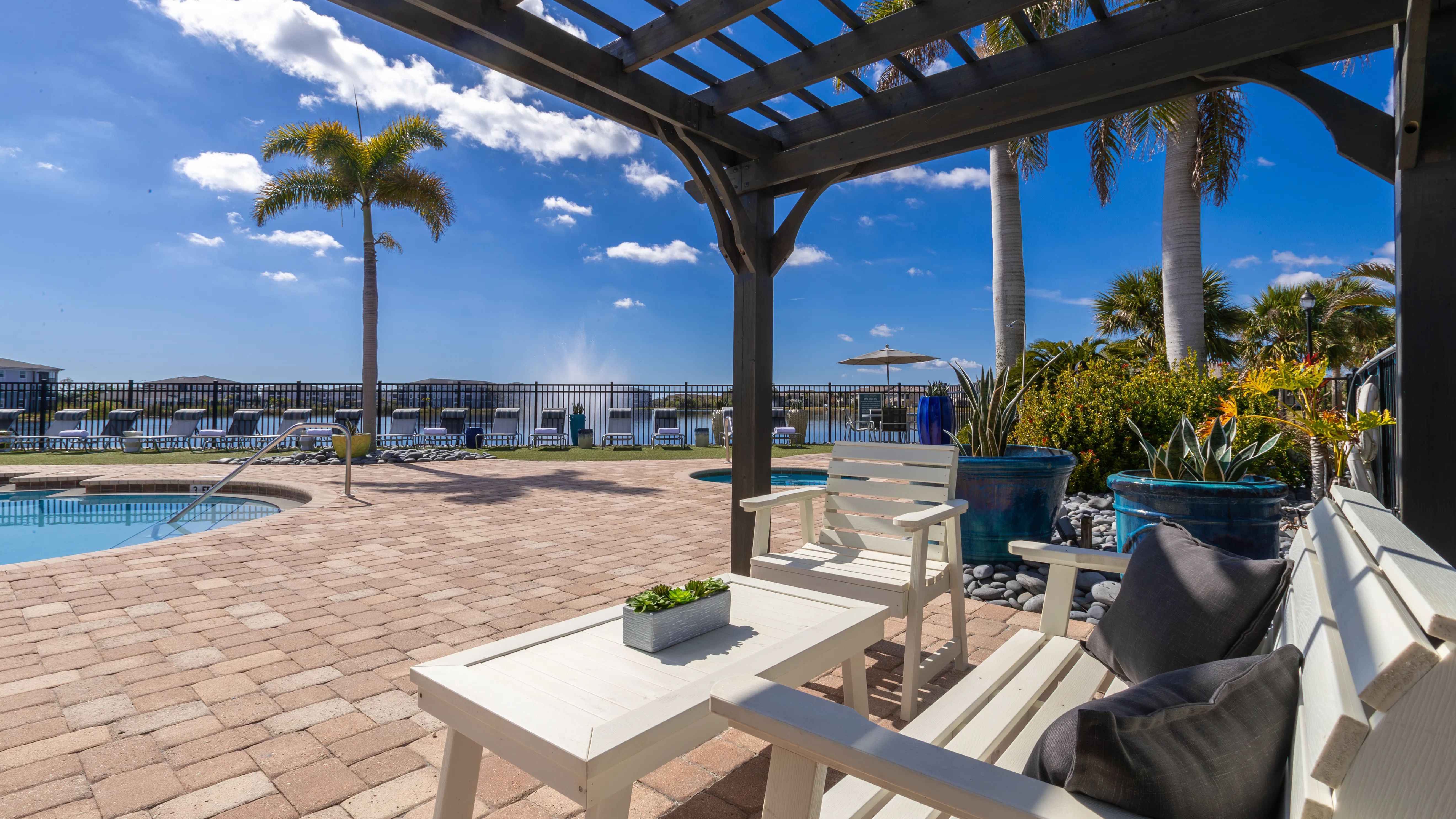 Unwind under the pergola and enjoy a peaceful poolside retreat in under the shade.