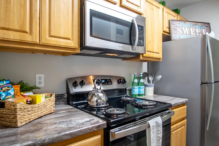 Sizzle and serve in the signature kitchen at Eagle's Pointe. Stainless steel appliances and stunning black fusion countertops create room for a culinary masterpiece.