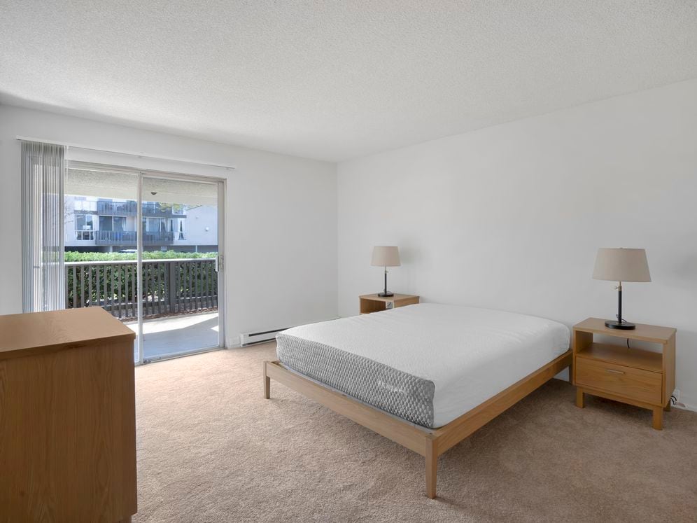 Furnished+ apartment homes feature queen bed with mattress, dresser, nightstands, and lamps (Representative Image – exact items and style of furnishings may vary)