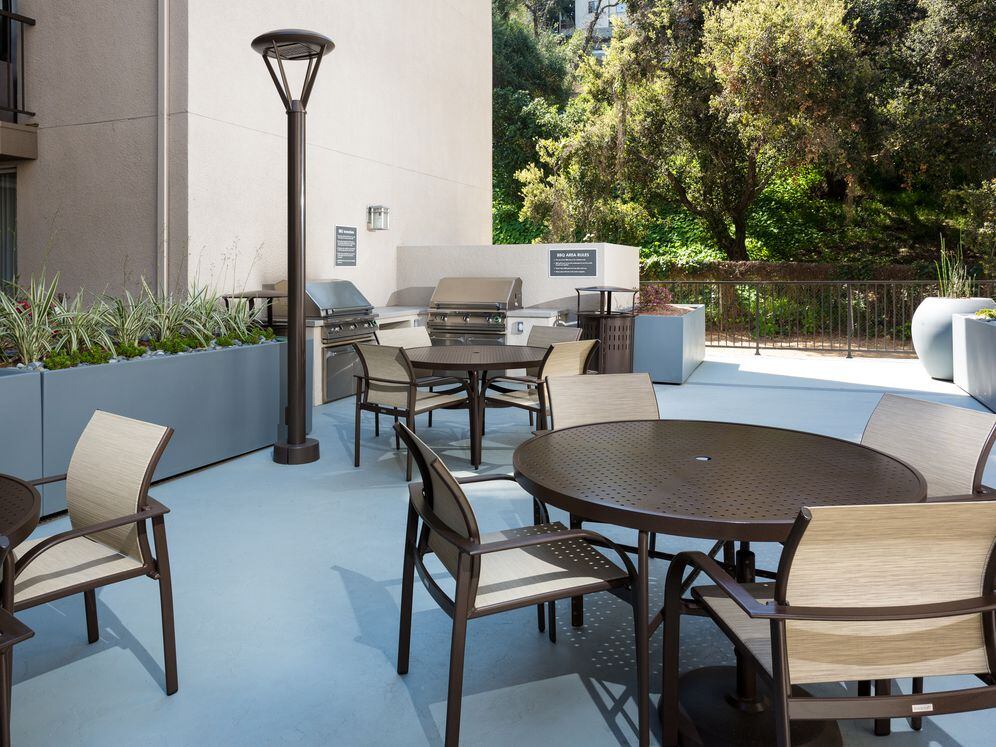 Resident courtyard with barbecue grills, fire pits, and lounge seating