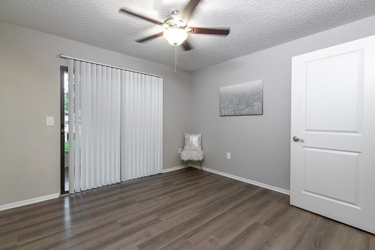 Spacious master bedrooms featuring wood-style flooring, a multi-speed ceiling fan, and sliding doors to your private patio/balcony.