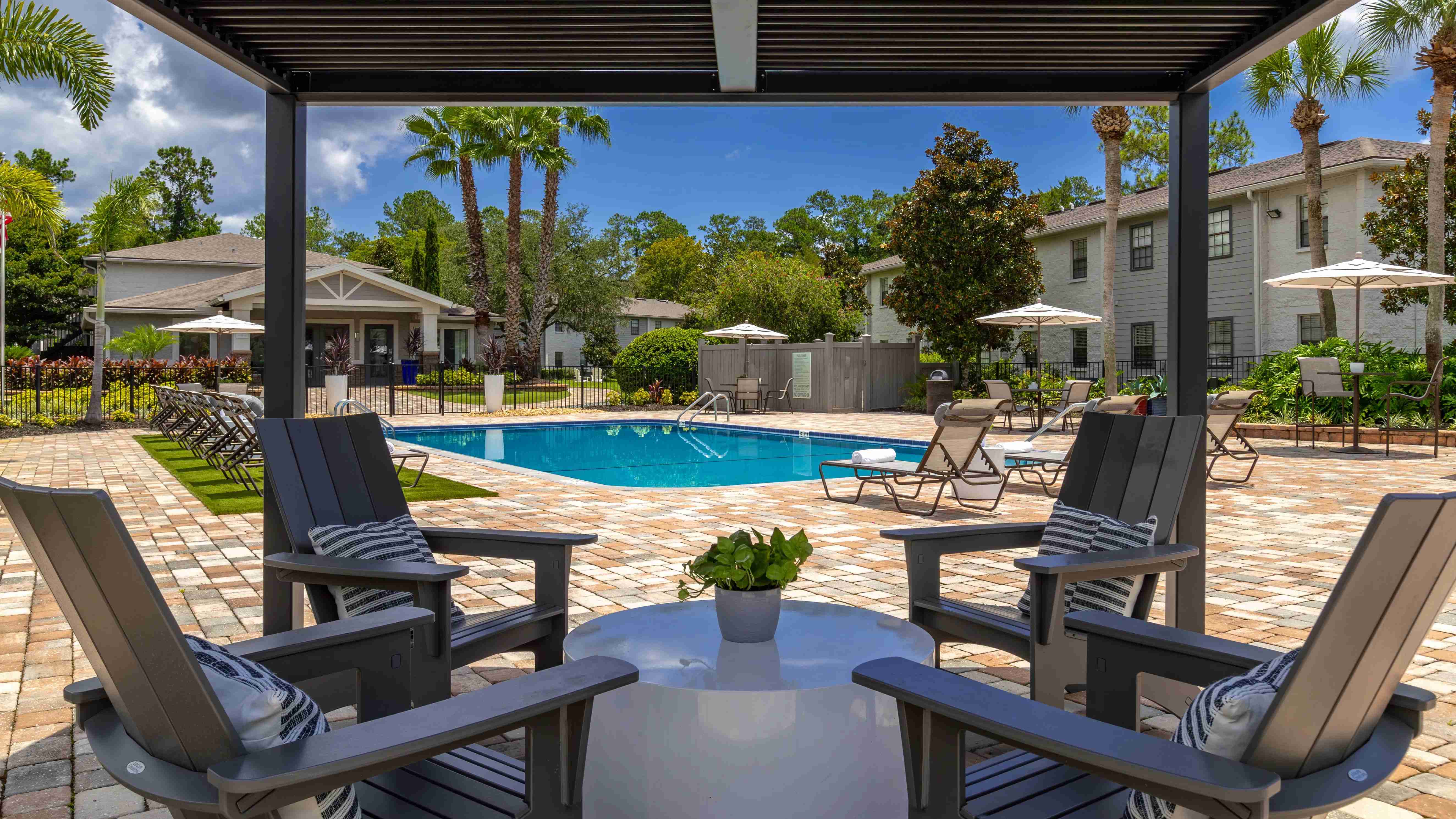 Engage in delightful conversations out of the sun at our poolside pergola. 