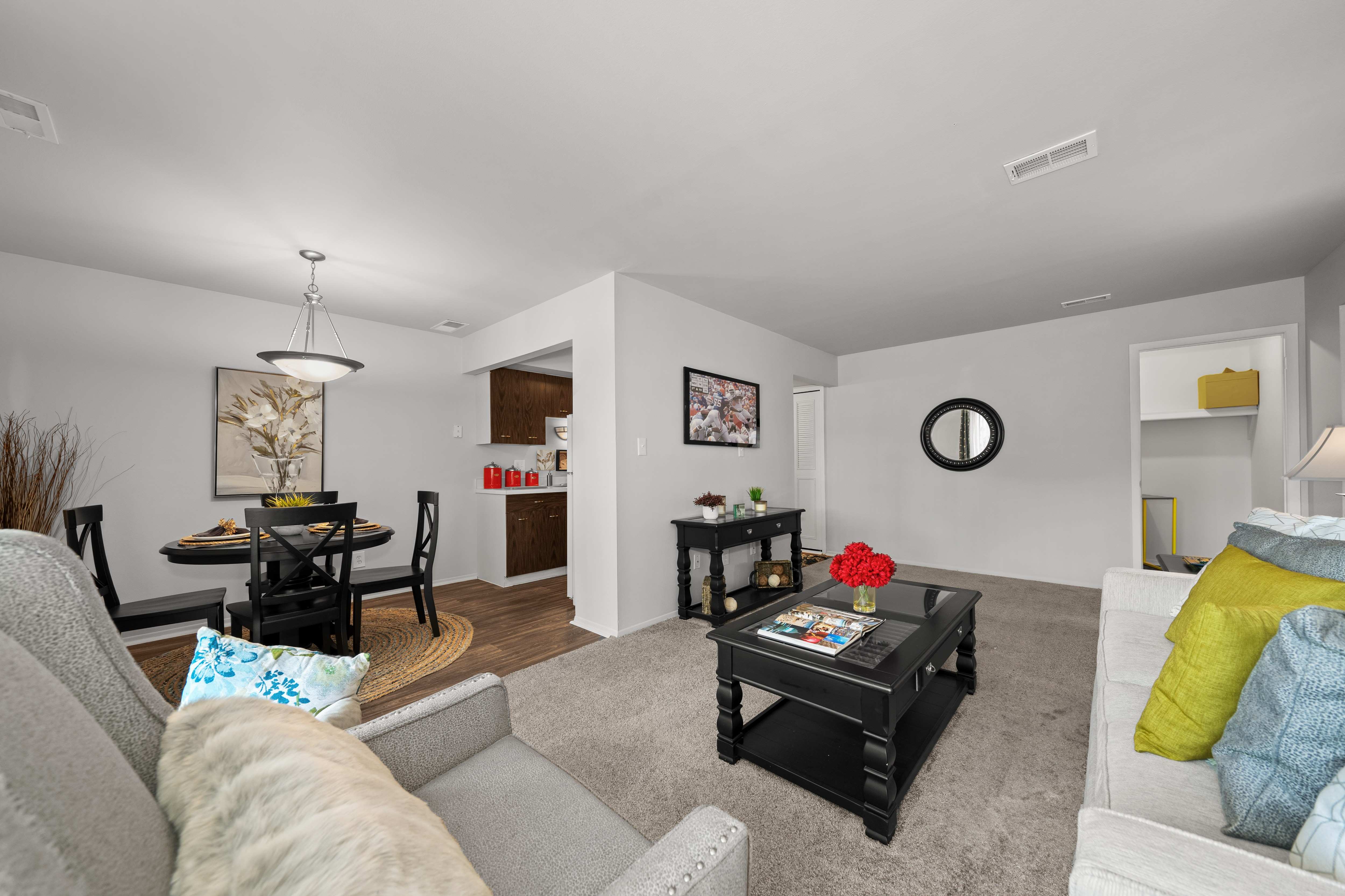 Open and airy living room with natural lighting at Knottingham Apartments in Clinton Township, MI.