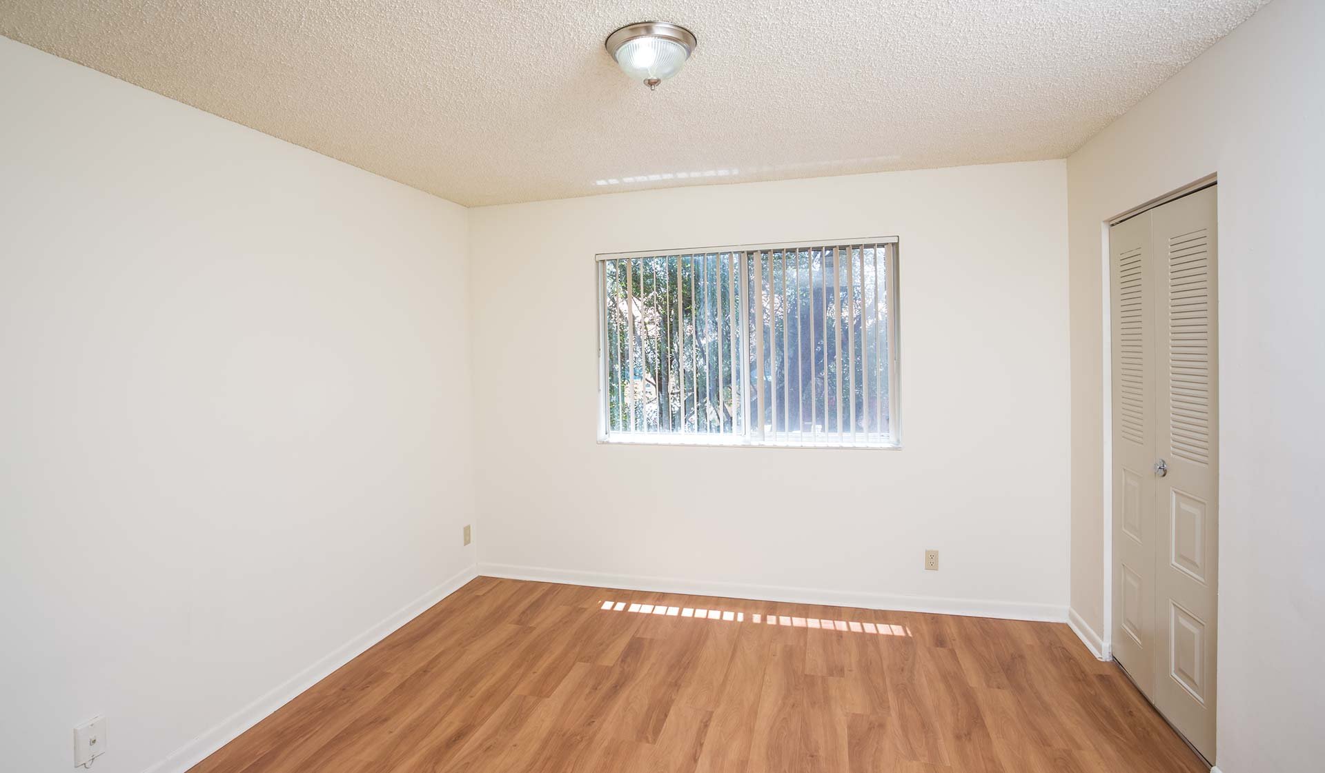 Bedroom feature walk-in closets and wood flooring throughout