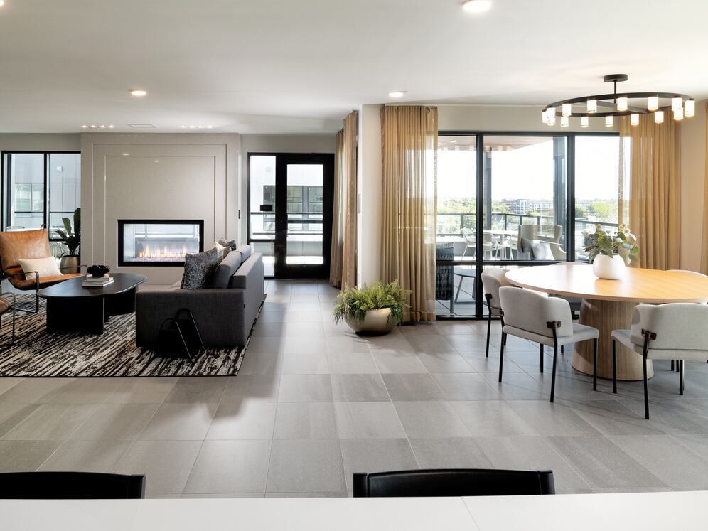 Rooftop resident lounge with kitchenette, fireplace, and ample lounge seating