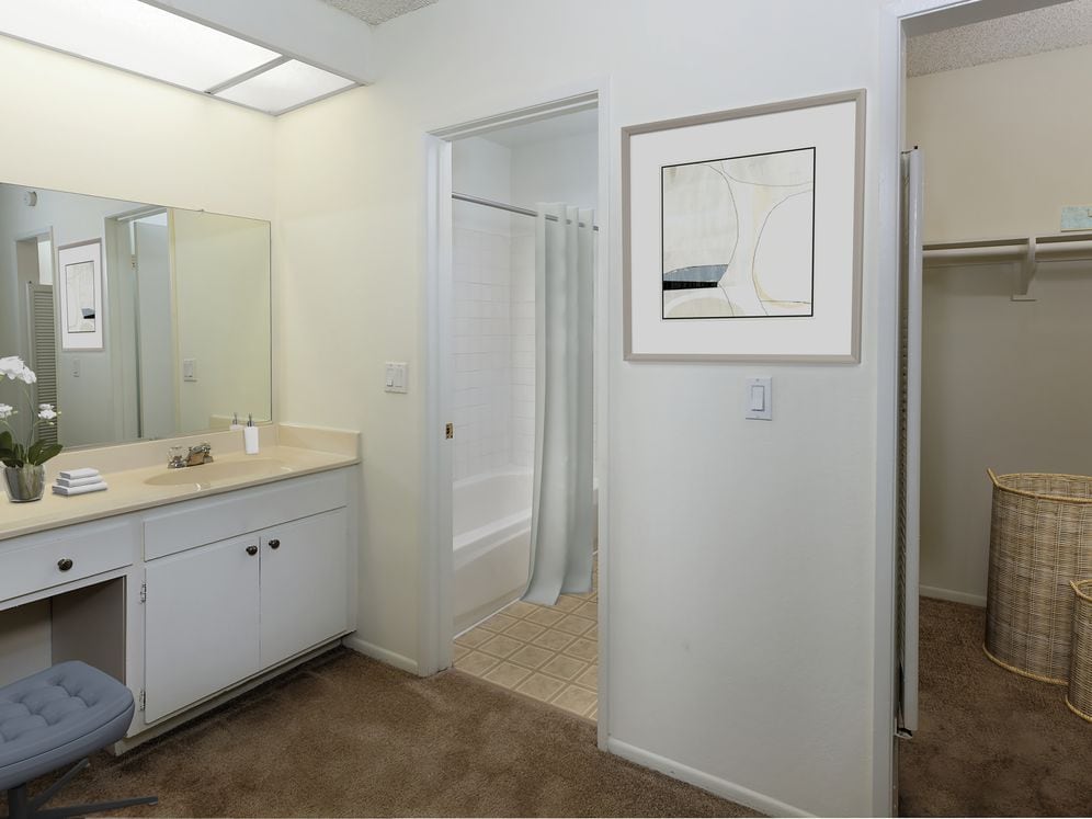 Classic bath with white cabinetry and tile flooring