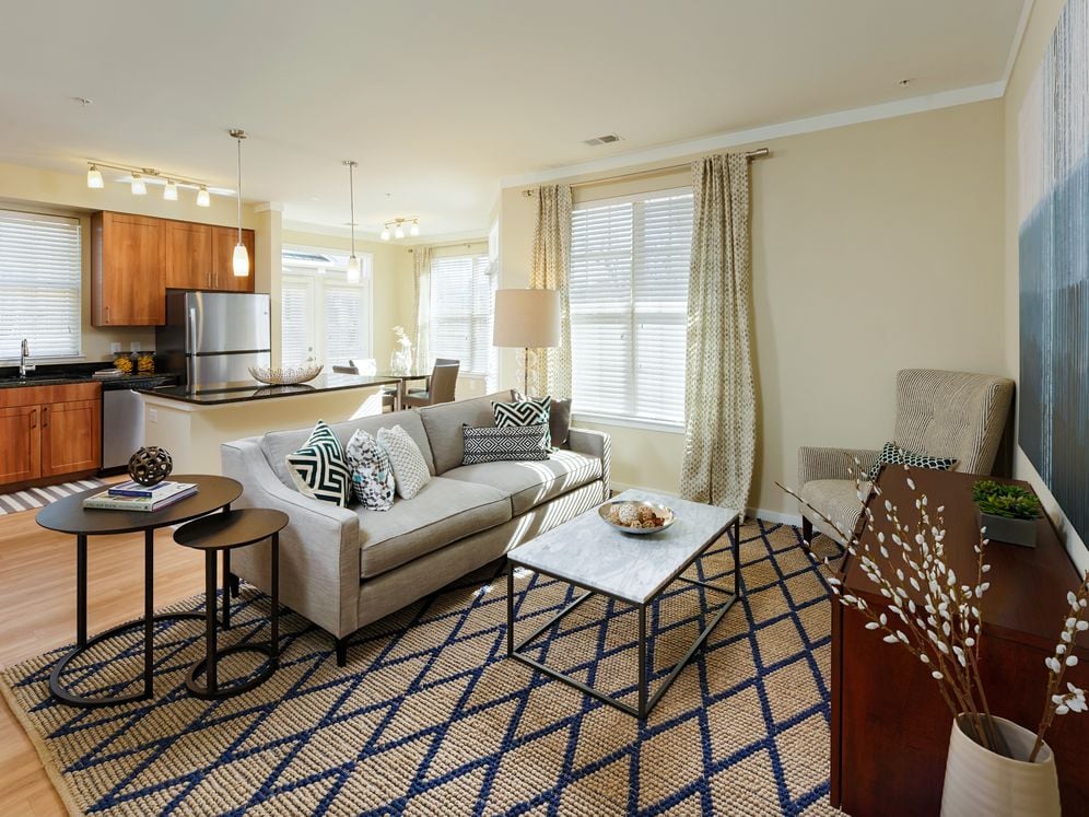Living area and kitchen with granite countertops, stainless-steel appliances hard surface flooring