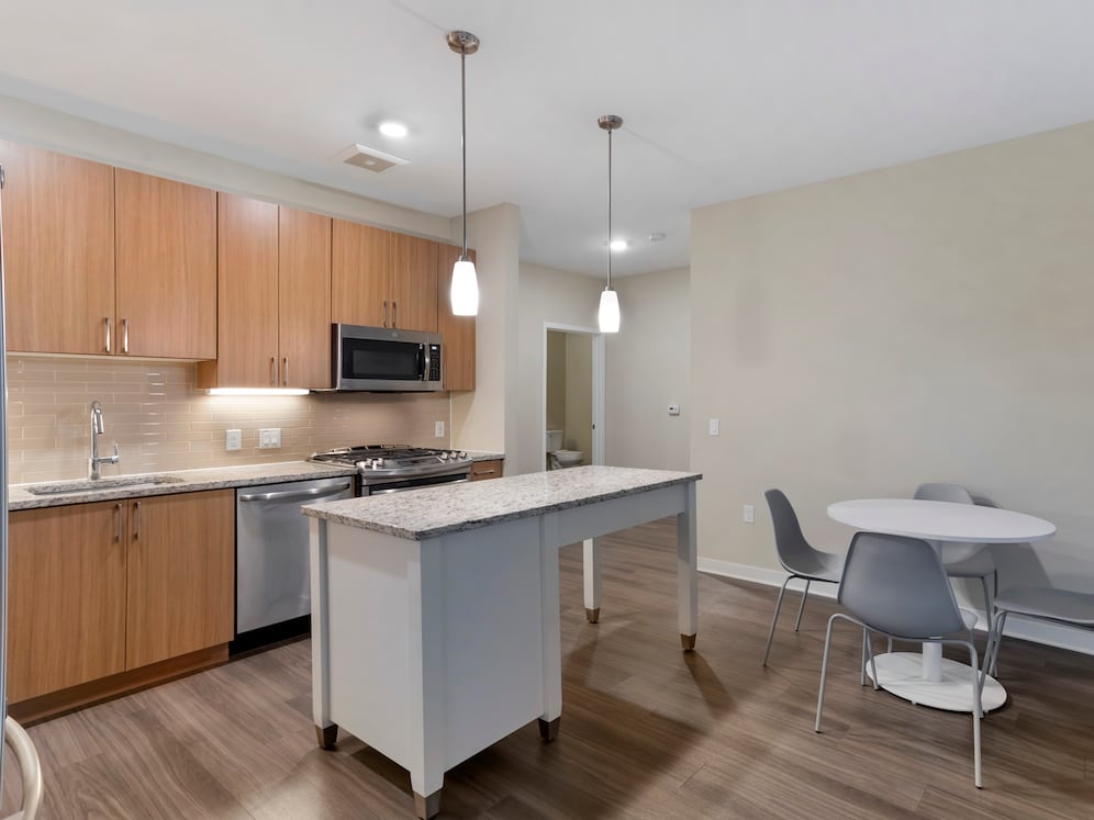 Furnished+ apartment homes include a dining set (Representative Image – exact items and style of furnishings may vary)