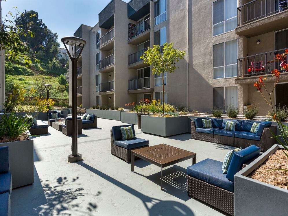 Resident courtyard with barbecue grills, fire pits, and lounge seating
