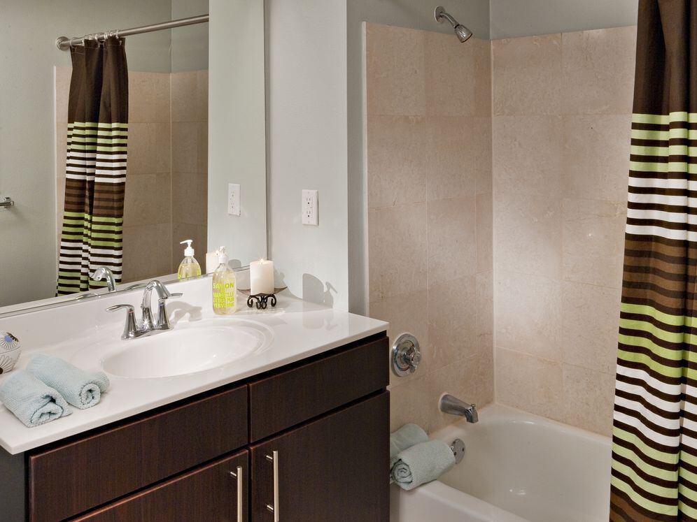 Classic Package I bath with espresso cabinetry, beige laminate countertop, and hard surface plank or vinyl tile flooring