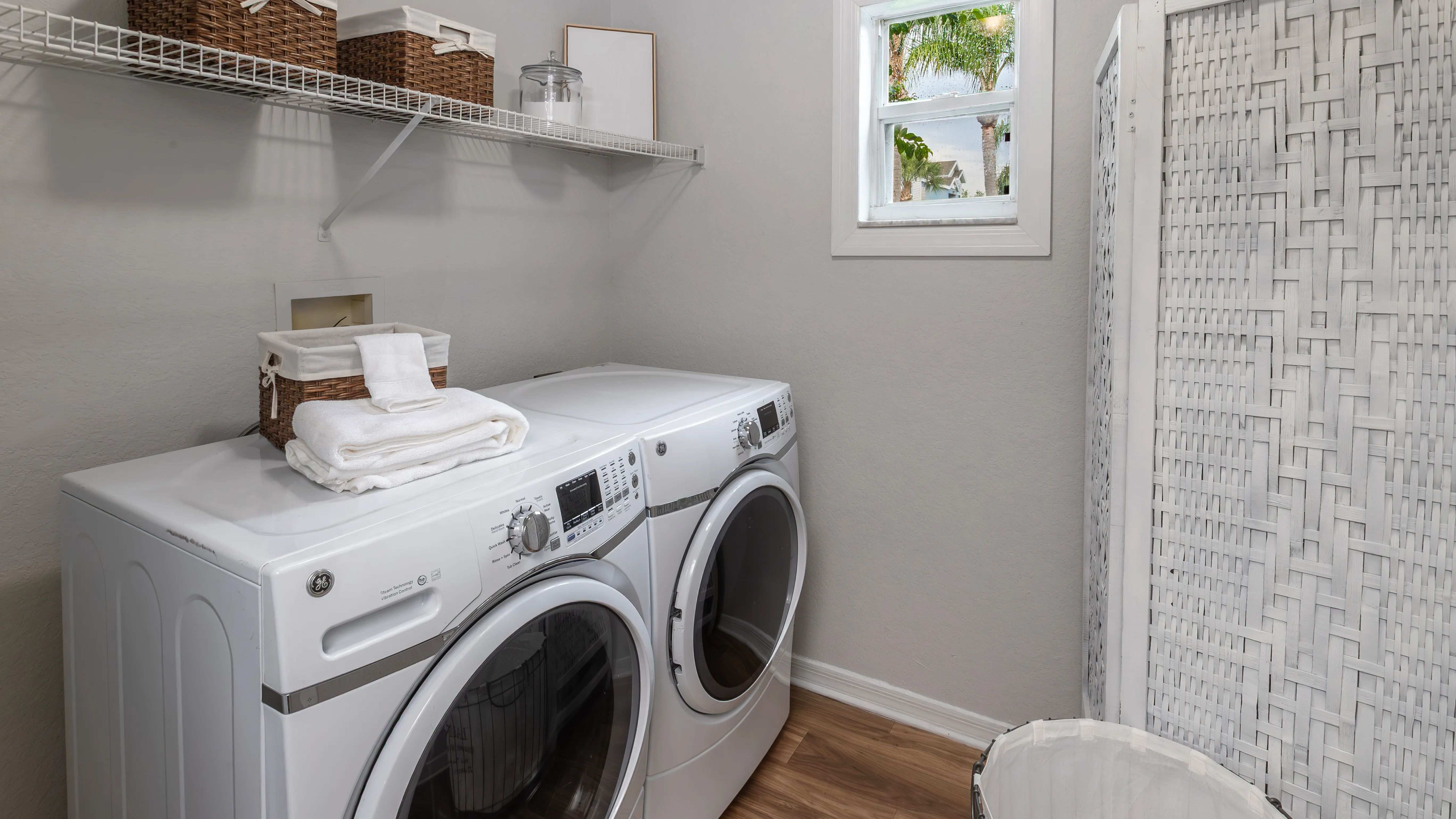 Enjoy the convenience of in-home laundry with a full-size washer and dryer, plus built-in shelving to keep everything organized.