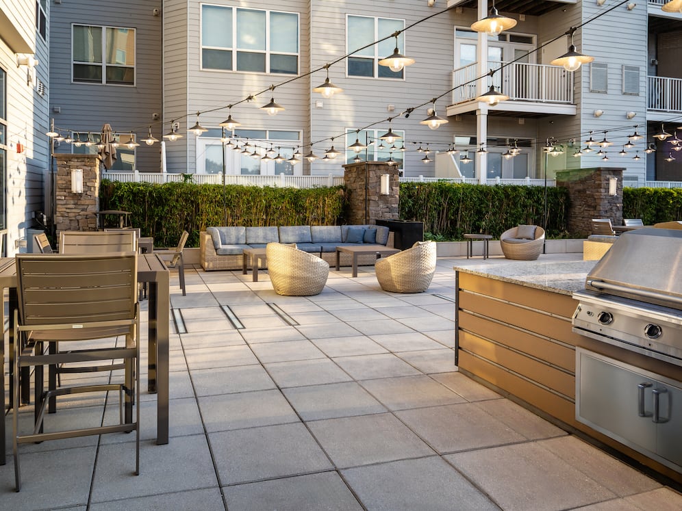 Rooftop patio with BBQ grills and lounge seating