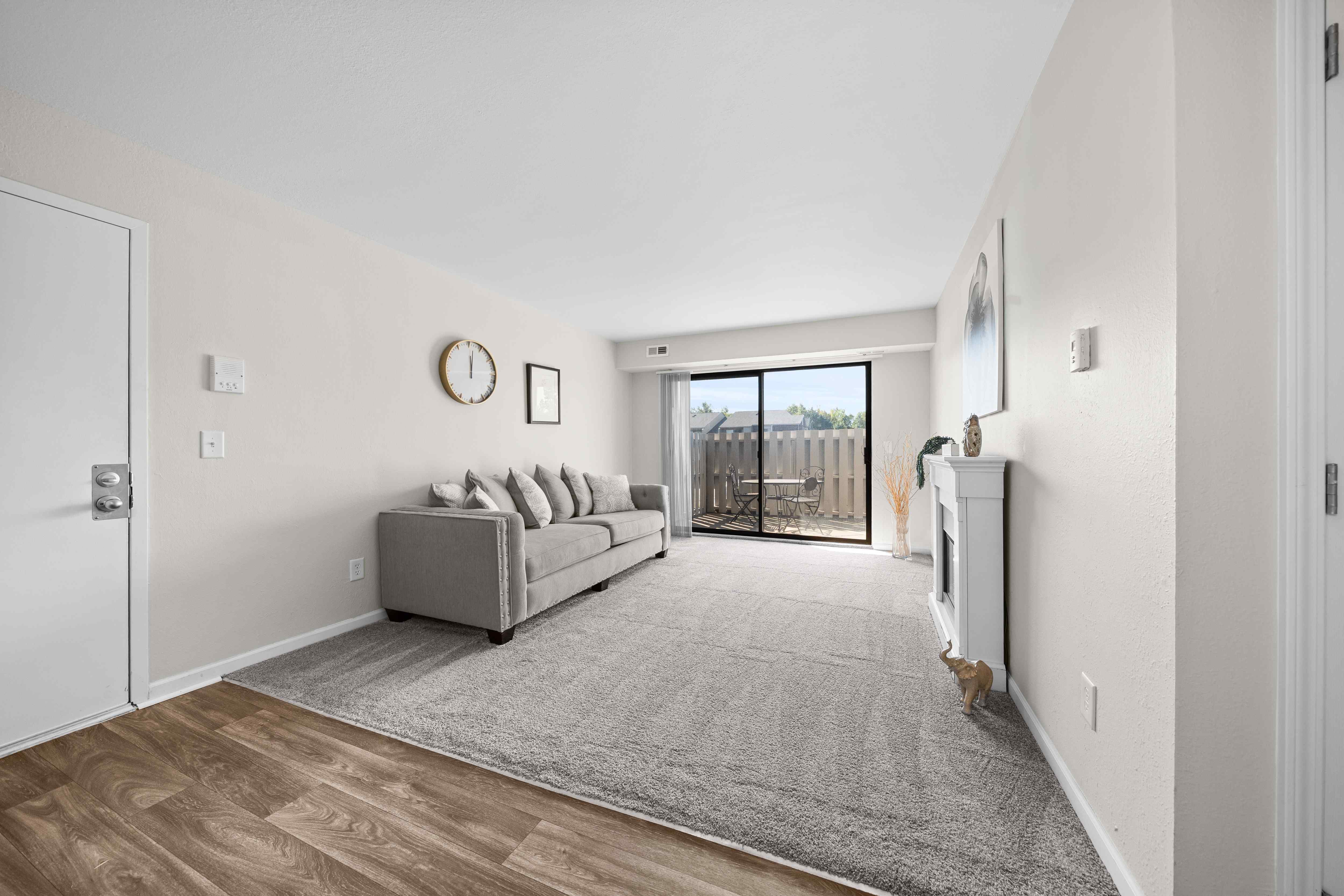 Large living room with patio at Three Oaks Apartments in Troy, Mi