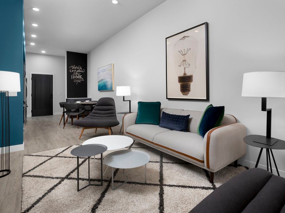 Building B Urban Design living area and kitchen with chalkboard accent wall