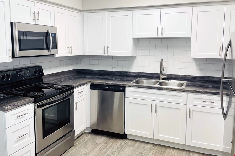 Experience kitchens with shining stainless-steel appliances and glimmering white subway tile backsplash - for a touch of modern elegance in all floor plans.