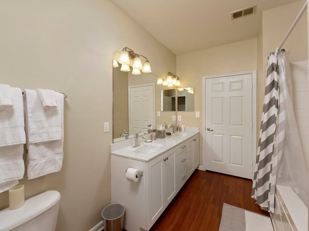 Classic Finish Package dual vanity bath with white cabinetry and hard surface flooring