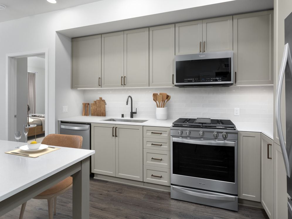 Building B Upgrade Design Kitchen with quartz countertops, backsplash, stainless steel appliances and island