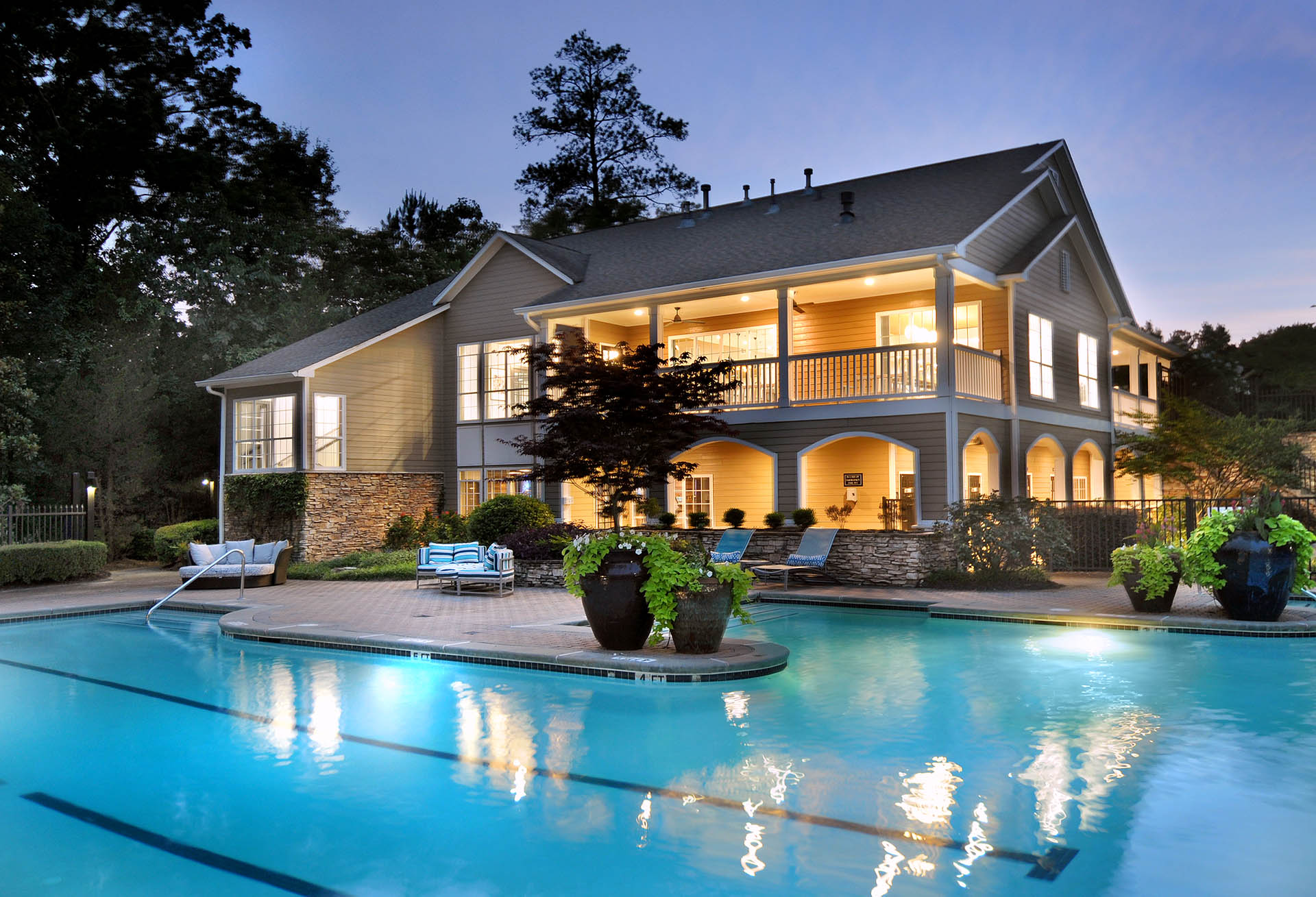 Beautifully lit pool and clubhouse at night