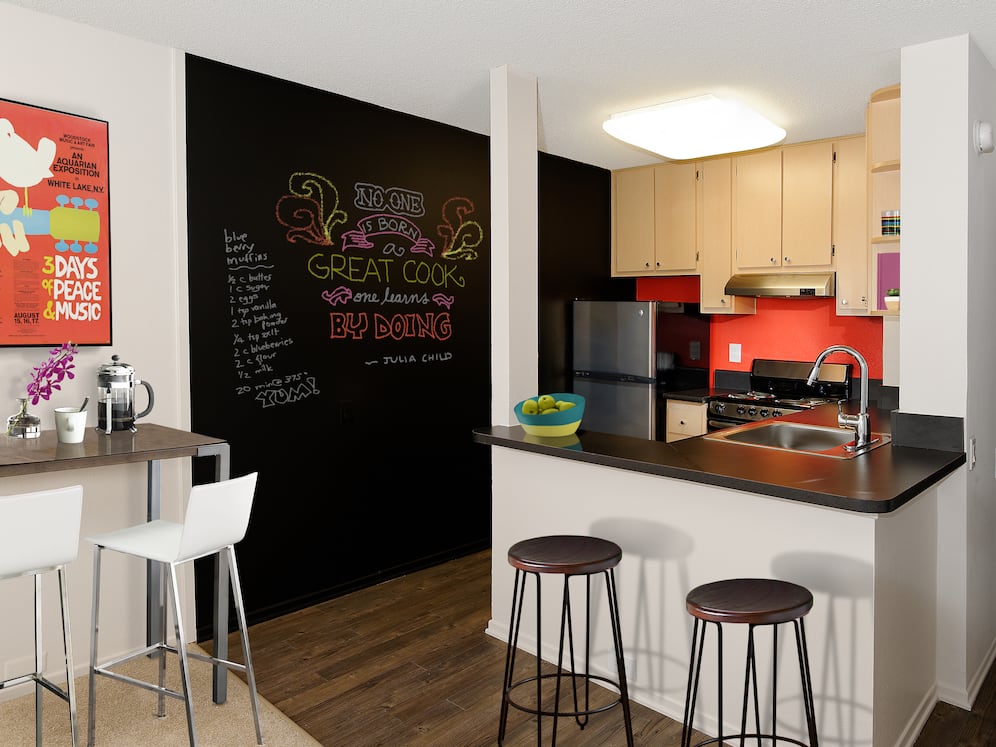Classic Package III kitchen with stainless steel appliances, black laminate countertops, oak cabinetry, and hard surface flooring