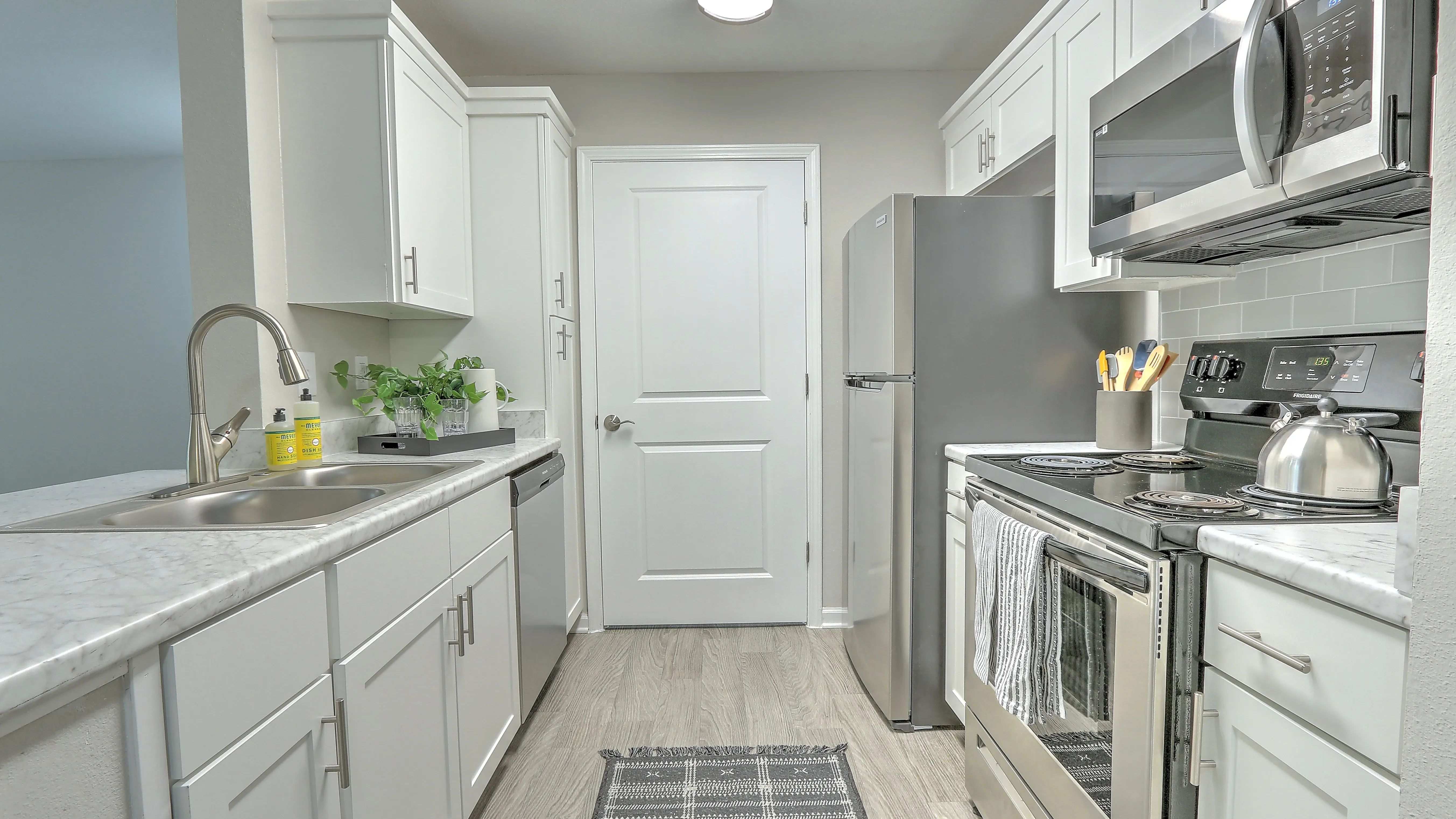 Discover designer kitchen elegance with ample storage in our updated kitchens.