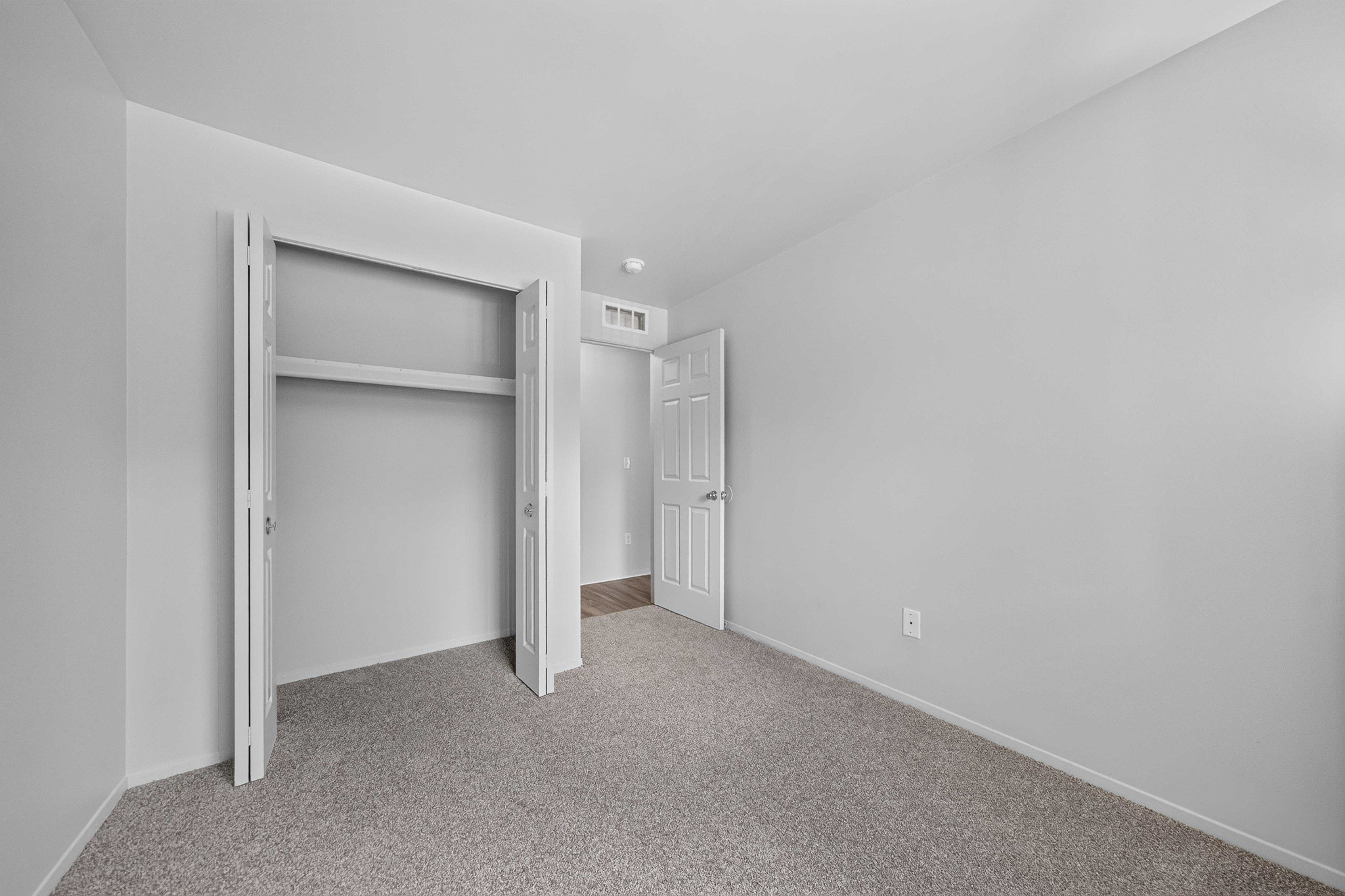 Cozy bedroom with ample storage at Woodland Villa Apartments in Westland, MI.