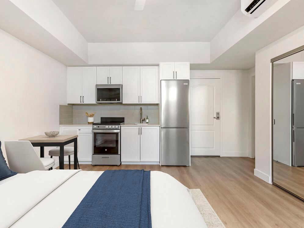 Renovated Package II kitchen, living, and dining area with hard surface flooring